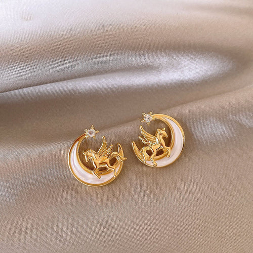 Main image 1 showing gold-tone crescent shapes enclosing a small horse motif and a pearl-like bead, styled product view