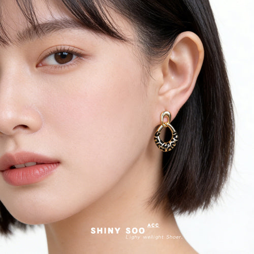 Gold leopard enamel drop earring worn on ear profile