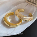 Seventeen Repeated Gold Or Silver Sculptural Open Cuff Designs view 1