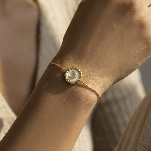 On-wrist view of crescent moon shell disc adjustable bracelets in main image 2.