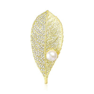 A fine filigree leaf with a round pearl-like accent shown on a white background