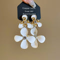 White Floral Drop Earrings with Crystal Centers and Gold Tone Studs view 1