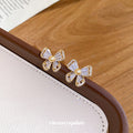 Gold Tone Bow Stud Earrings with Clear Stones and Pearl Centers view 4