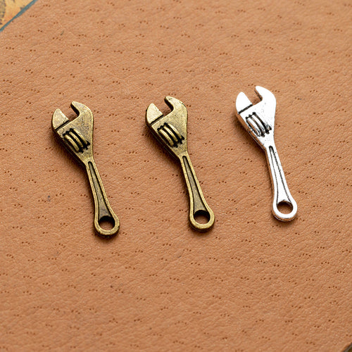 Mini adjustable wrench charm components displayed in multiple metal finishes