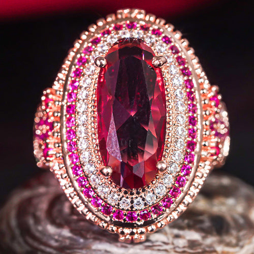 Front-facing red oval multi-halo cocktail ring close-up