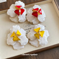 White Petal Enamel Flower Stud Earrings with Polished Metal Tone Details view 2