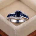 Black And Blue Round Stone Swirl Ring In Four Metal Finishes view 8