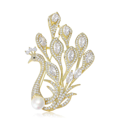 Gold crystal peacock brooch with pearl on white