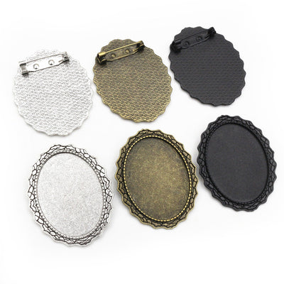 Decorative Oval Cabochon Brooch Bases With Top Loop in Three Finishes shown in a grouped front view