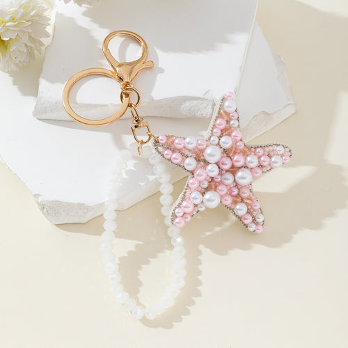Pink and white pearl beaded starfish keychain with a white beaded wristlet strap