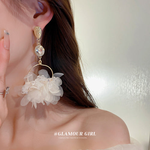 White Petal Cluster Gold Hook Earrings Polished Metal Jewelry modeled at the ear
