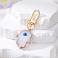 Gold Tone Druzy Style Hamsa Evil Eye and Pressed Flower Clip Keychains view 4