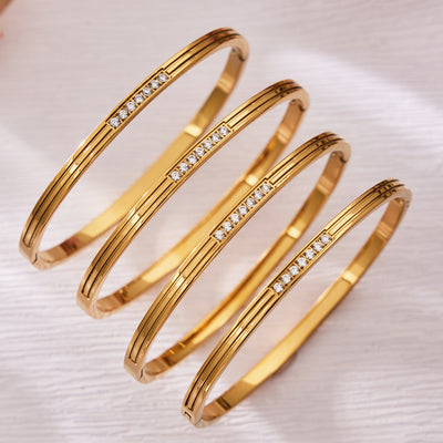 On-wrist view of grooved crystal hinged bracelet in main image 1.