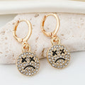 Gold Tone Crystal Smile and Frown Medallion Huggie Earrings view 2