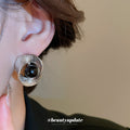 Silver Textured Round Stud Earrings with Black Centers view 3