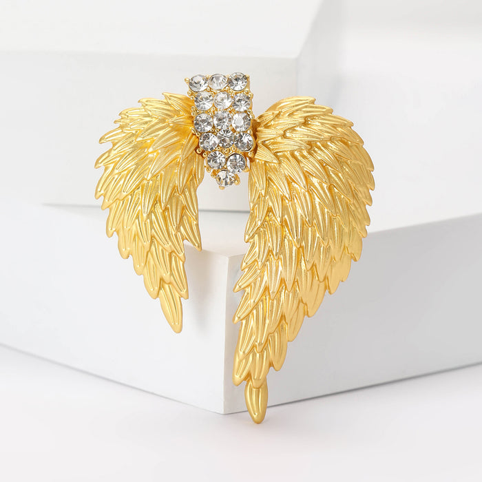 Gold Tone Layered Angel Wing Brooch With Crystal Center