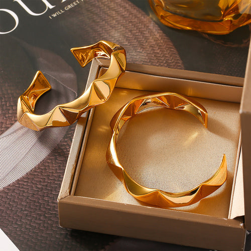 Gold open cuff bracelets in a satin-lined gift box
