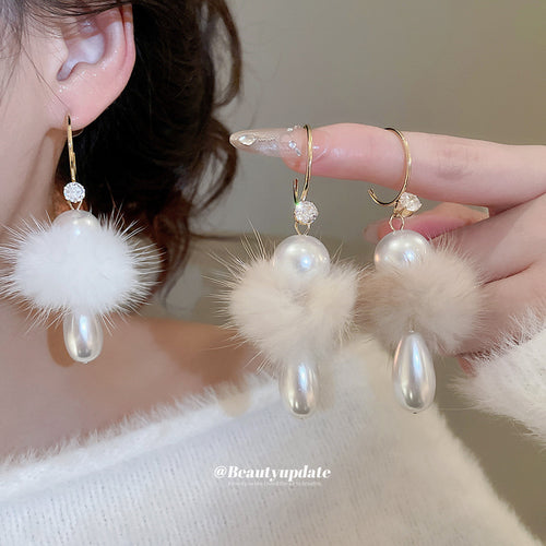 Main image 2 showing fluffy white pom-poms, pearl-like drops, and slim gold-tone fish hooks, arranged detail view