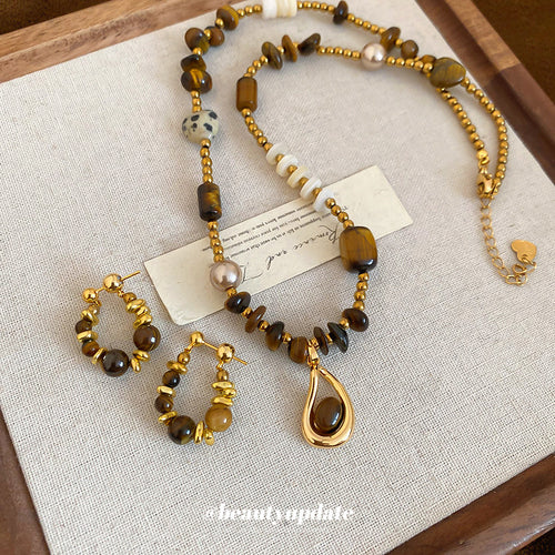 Gold brown stone beaded necklace and hoop earrings flat lay