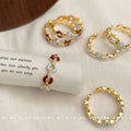 Gold Tone Chain Link Open Rings With Blue And Red Oval Stones view 1