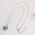 Gold Tone Heart-Shaped Blue Evil Eye Necklace and Huggie Earrings view 5