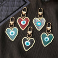 Gold Tone Swirled Heart Evil Eye Clip Keychains in Five Colors view 1