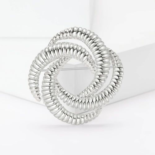 Product image 2 showing the textured interlocking loop brooch in silver or gold.
