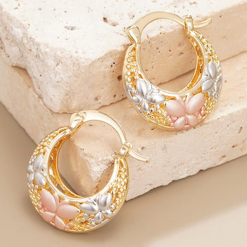 Alternate close view of the gold tone earrings