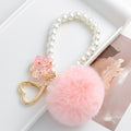 Pink Faux Fur Pom Keychain with Pearl Strand and Glitter Flower Charm view 2