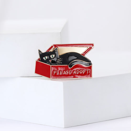 Cat In Adoption Box Brooch displayed at an angle