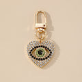 Gold Tone Rhinestone and Faux Pearl Heart Evil Eye Clip Keychains view 3