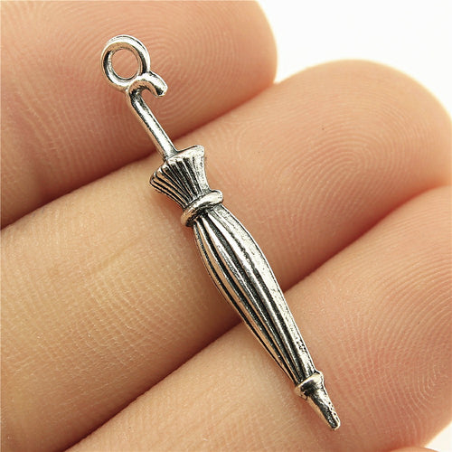 Antique Bronze, Antique Silver closed umbrella charm front view on fingertips