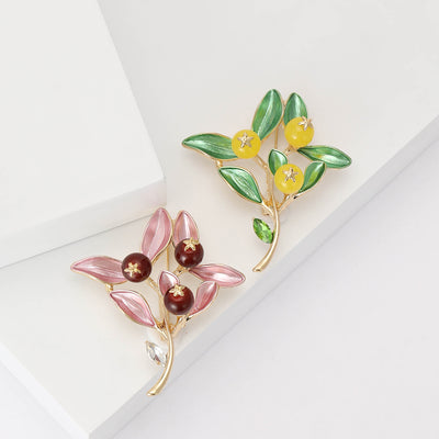 Front product view of the enamel leaf branch brooch on a light background
