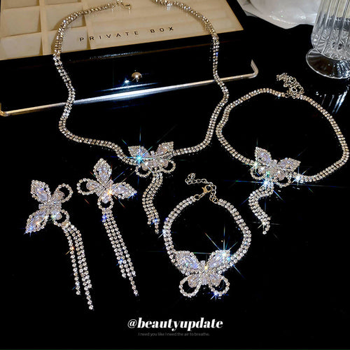 silver-tone iridescent butterfly crystal necklace and long fringe earrings shown in the first close product view