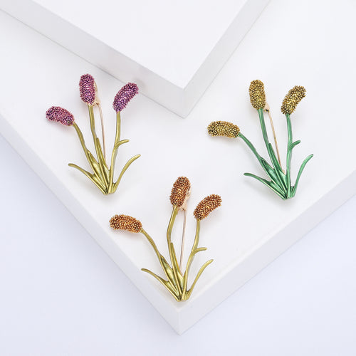 Three cattail plant brooches purple orange and yellow green