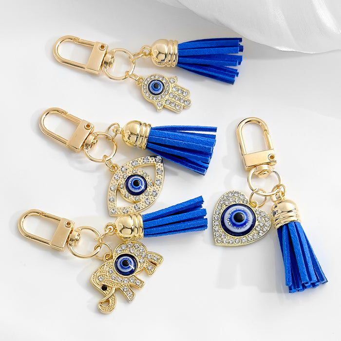 Gold-Tone Rhinestone Evil Eye Keychain with Blue Suede Tassel