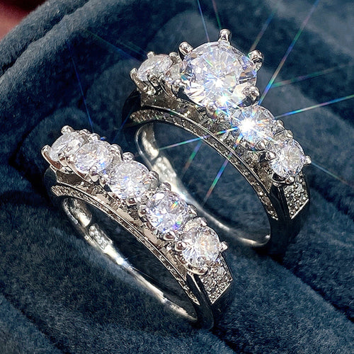 Dual stack solitaire and band rings angled on dark blue velvet