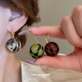 Gold Tone Hoop And Stud Earrings With Marbled Resin Ball Drops view 2