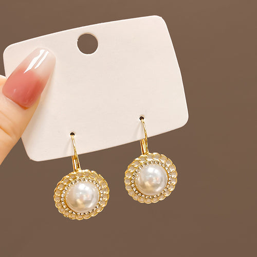 Gold pearl leverback earrings white braided rim on white card in hand