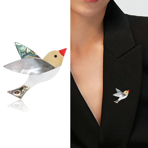 Angled display of geometric bird with a red beak and layered iridescent wing and tail inlays