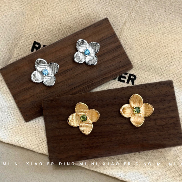 Silver Brushed Flower Stud Earrings Blue Center Stone