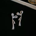 Crystal Bow Tassel Earrings with Asymmetric Silver Tone Drops view 6