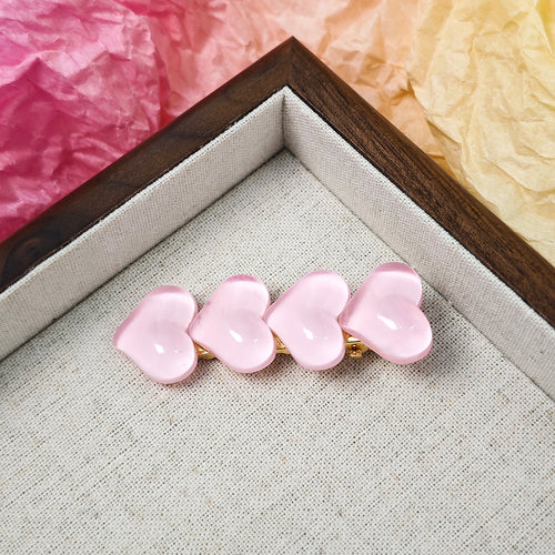 Pale pink translucent heart hair clip on fabric tray