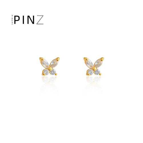 Gold-tone mini butterfly zircon studs on white reflection
