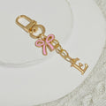 Gold Tone Initial Letter Keychain With Pink Enamel Bow Charm view 10
