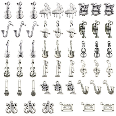 Antique silver guitar charms arranged on a light background