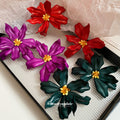 Oversized Red Sculpted Flower Stud Earrings with Gold Tone Centers view 1