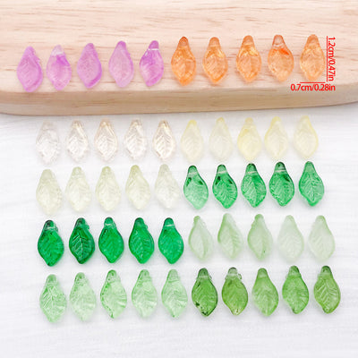 Mini translucent glass leaf beads arranged as a full product overview