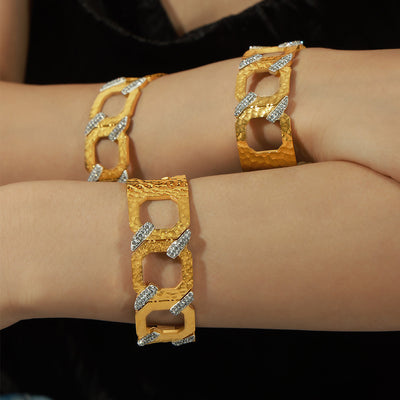 Gold geometric crystal link bangles worn on arms