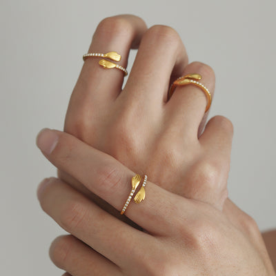 Model hands wearing gold hugging hands zircon open rings